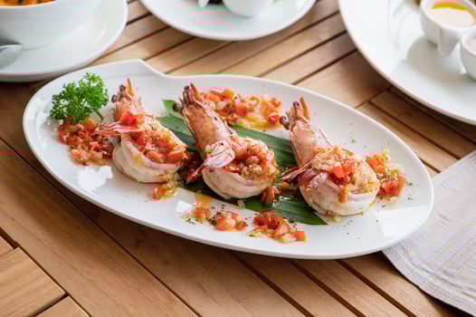 Spicy chili grilled prawns in white plate photo