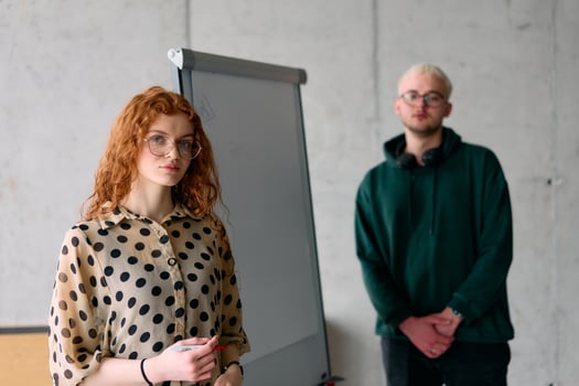 A business colleague collaboratively presenting business goals and strategies to their team in a professional office setting photo