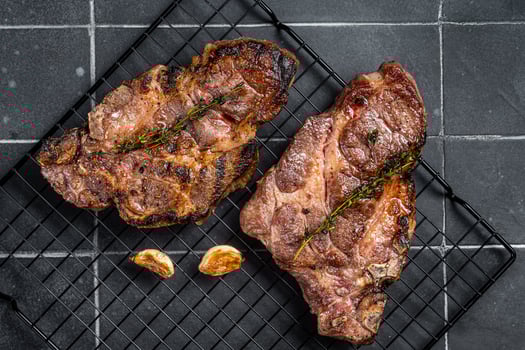 BBQ Grilled Pork loin steaks, neck meat. Black background. Top view photo