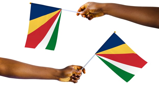 Outstretched Black african Hands holding Seychelles national flag isolated over white background, protest, waving, freedom, Seychellois photo