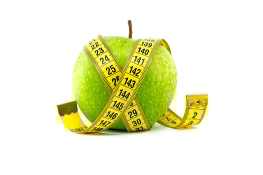 Healthy Green Apple with Measuring Tape Isolated on White Background photo