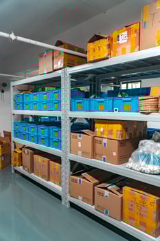 Organized warehouse shelving with boxes and bins for improved inventory management photo