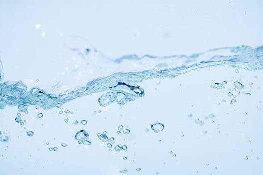 Water splash isolated on white background, Air Bubbles Float Up Under Blue Water. Pure Water Wave, Oxygen Relaxation. Blue bubbles Water Textured. photo