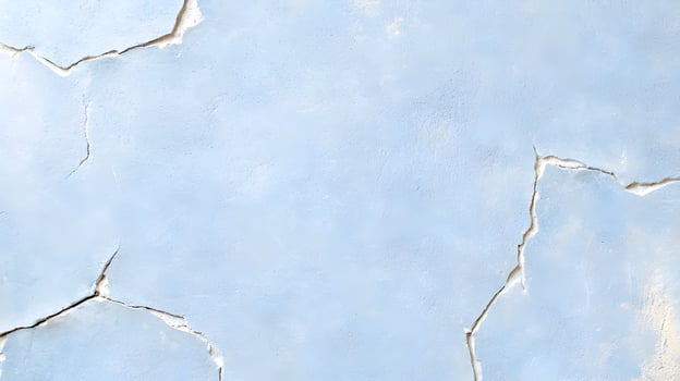 A wall with a blue background and a white crack photo