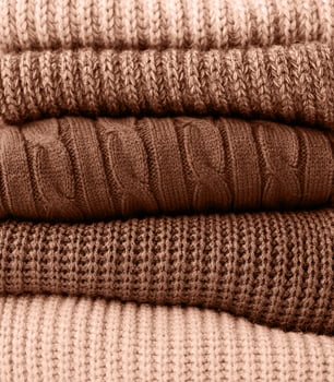 Mocha Mousse - color of the year 2025. Stack of autumn warm sweaters photo