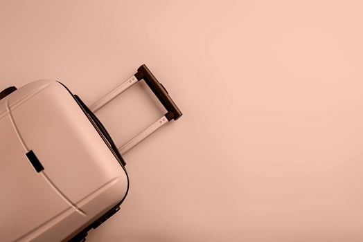 Mocha Mousse - color of the year 2025. Top view travel bag or suitcase on solid background copy space. Tourist essentials photo