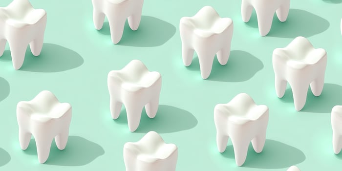 Repeating pattern of stylized white teeth on mint green background photo