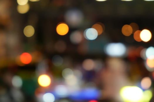 A blurred city street image at night. Abstract blur urban city street road with lighting bokeh for background. photo