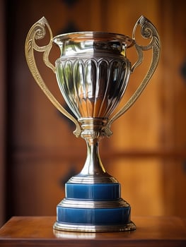 Ornate trophy cup on wooden table photo