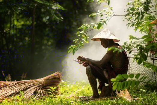 A tattooed elderly man smoking a cigarette in the garden photo