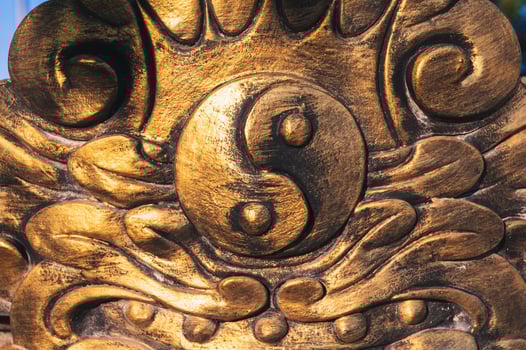 The golden Yin-Yang symbol on the temple wall photo