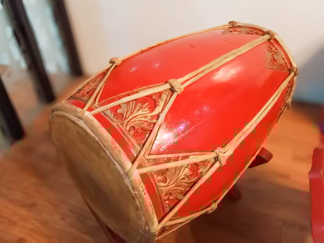 Kendang, kendhang, gendang. Traditional Javanese kendang drums, part of the musical instruments in a gamelan orchestra, feature intricate carvings and a rich red color. photo