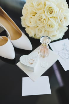 Accessories of the bride. Wedding shoes for the bride. White high-heeled shoes near wedding rings, wedding jewelry. photo