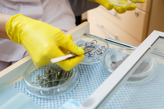 Dentist with a dental tool in his hands in a dental office. Dentistry. Close-up photo
