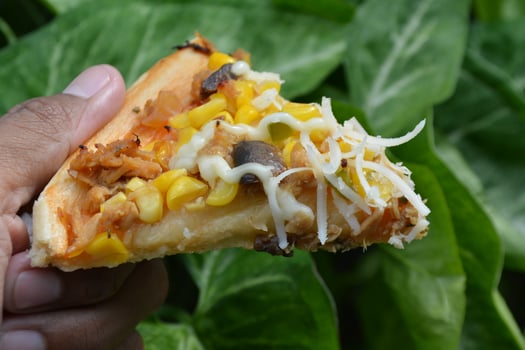 Delicious pizza with topping sausages, cheese, and corn, delicious meal to eat photo