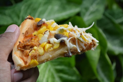 Delicious pizza with topping sausages, cheese, and corn, delicious meal to eat photo