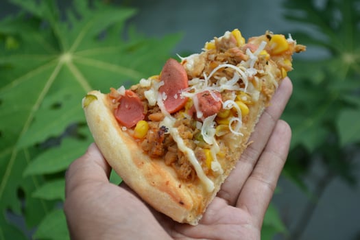 Delicious pizza with topping sausages, cheese, and corn, delicious meal to eat photo