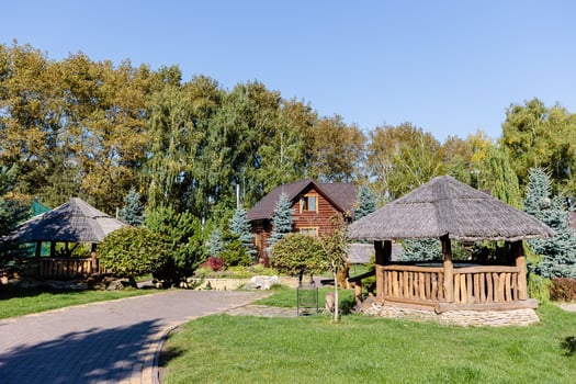 Beautiful wooden gazebo for outdoor recreation. Place in nature with a wooden house photo