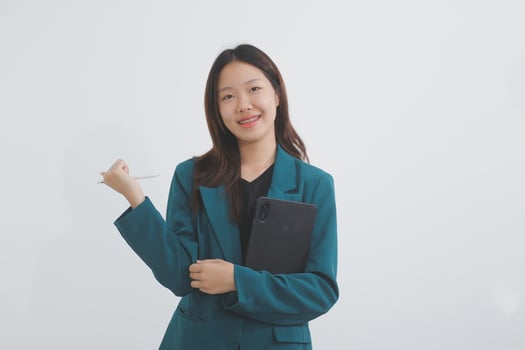 Attractive elegant young asian business woman using digital tablet standing on isolated background. Happy young latin female formal black suit holding tablet gadget working service with customer photo
