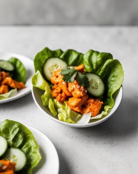Spicy Buffalo Chicken Lettuce Wraps with Cucumber Slices and Cilantro photo