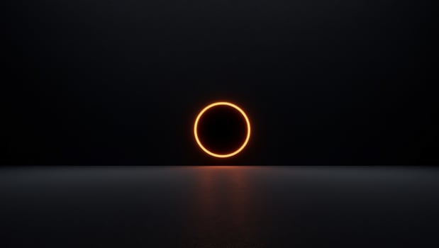 A black background with a glowing orange circle in the center. photo