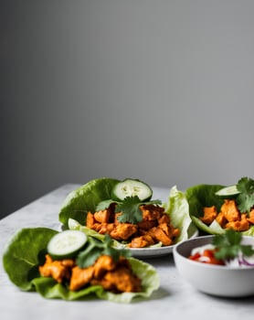 Spicy Buffalo Chicken Lettuce Wraps with Cucumber Slices and Cilantro photo