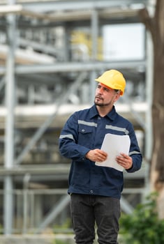 Petroleum engineer is on a mission to inspect oil distillation at a huge oil refinery photo