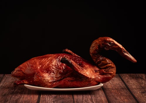 Grilled Beijing duck, roast duck on wooden table on black ground, Chinese Style Cuisine - Roasted Peking Duck. A plate of food delicious. photo