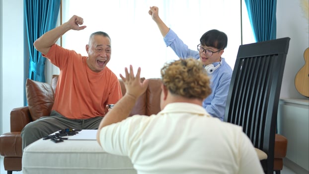 A father with grandchild plays games together in the living room to relax during the holidays photo