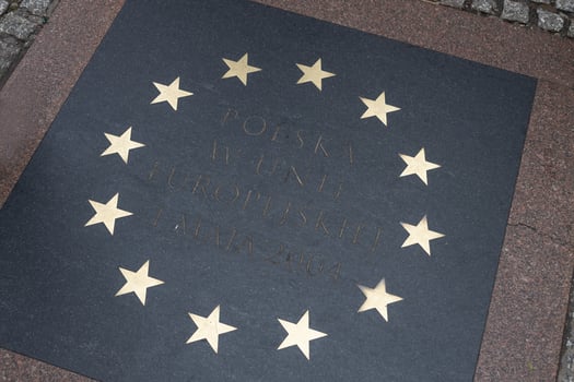 Krakow, Poland. 8 December, 2024 Commemorative EU plaque in Krakow Market Square photo