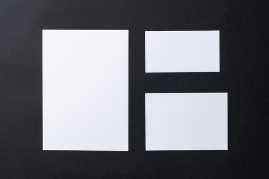 White blank business cards on dark black background photo