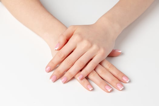 Well-groomed female hands with manicure on white background photo