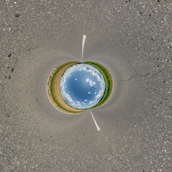 blue hole sphere or globe little planet inside green dry grass or stone with sand frame background photo