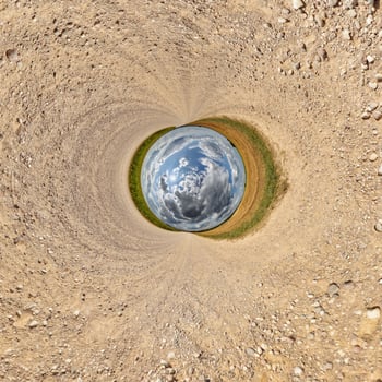 blue hole sphere or globe little planet inside green dry grass or stone with sand frame background photo