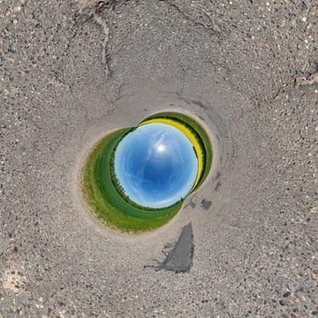 blue hole sphere or globe little planet inside green dry grass or stone with sand frame background photo