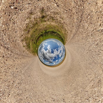 blue hole sphere or globe little planet inside green dry grass or stone with sand frame background photo