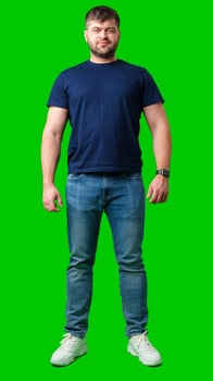 A man standing confidently against a bright green backdrop photo