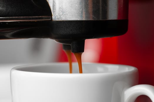 Americano coffee pouring from home coffee machine photo