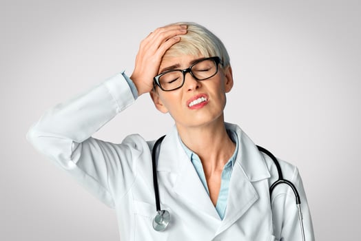 Forgotten and confused concept. Upset woman doctor closes eyes and press hand to head, panorama, free space photo