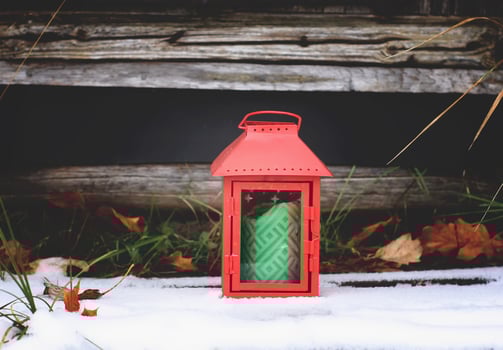 Decorative lantern with burning candle in autumn park at evening. photo