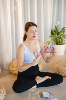 A sporty girl lays out Tarot cards indoors. Tarot cards in the hands of a fortune teller photo