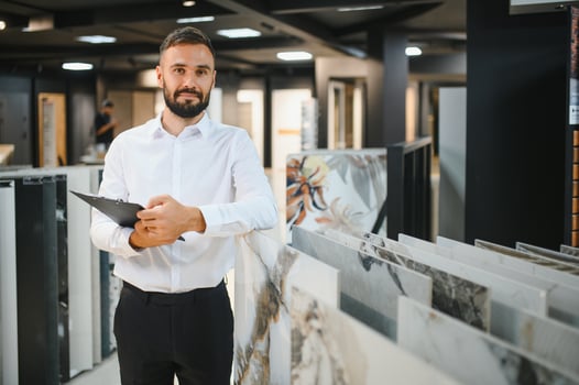 A male seller of ceramic tiles in a hardware store photo