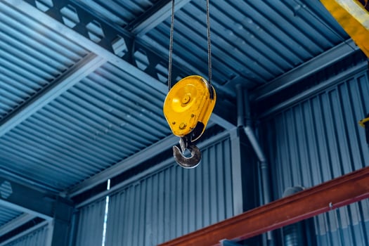 Industrial crane hook in a modern factory building photo