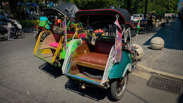 Pedicab Parked on Urban Street in Bright Daylight, pedicab or rickshaw or locals calls it becak with a canopy is parked on a sunny street, reflecting a vibrant urban scene photo