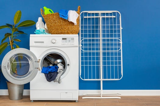 Laundry room interior with washing machine and clothes dryer near wall photo