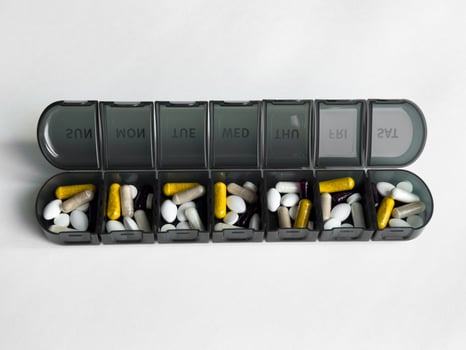 Weekly pill organizer with supplements for daily health management photo