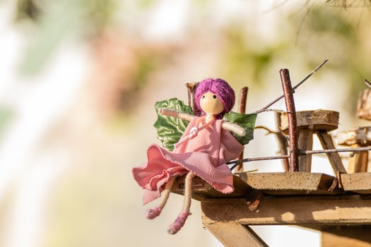 handmade toy fairy for christmas decoration, seated with out of focus background photo