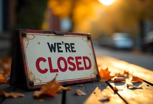 we're closed sign on a bench photo