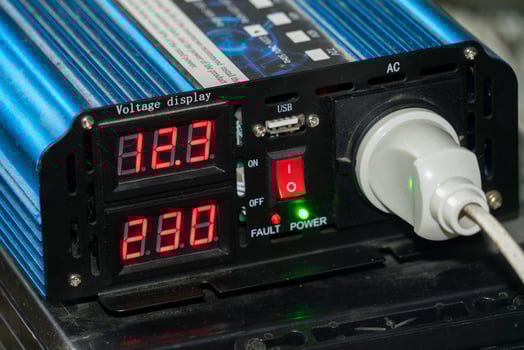 Voltage inverter displaying power readings with USB ports photo