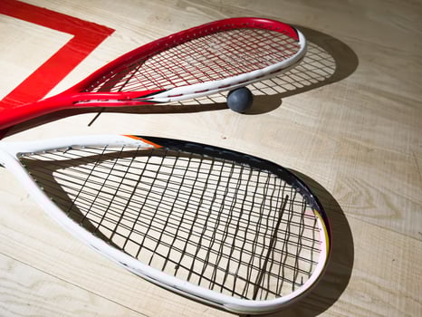 Empty squash court and rackets on the wooden floor. photo